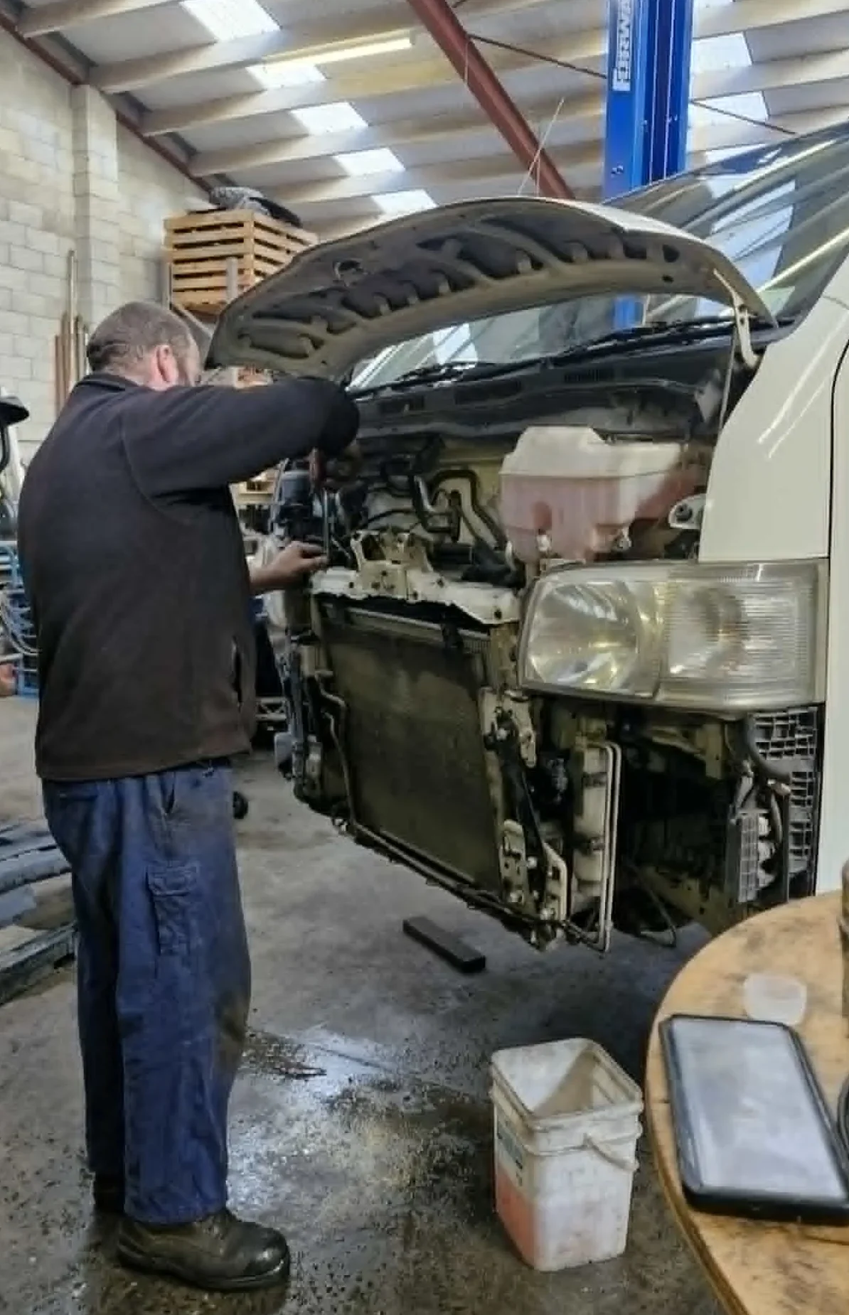 Mechanic carrying out radiator replacement at Holland Automotive in Whanganui